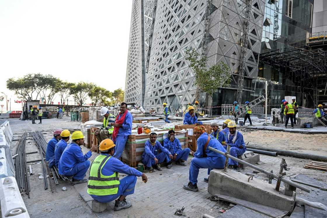 Migrant builders take a break while working at a construction site by the Corniche in Doha during the World Cup Migrant builders take a break while working at a construction site by the Corniche in Doha during the World Cup