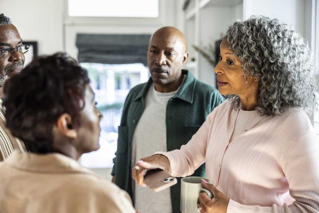 A group of relatives gossiping A group of relatives gossiping