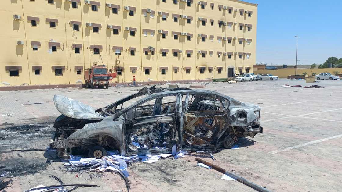A burnt vehicle outside the House of Representatives in the eastern city of Tobruk, seen on July 2, 2022, after angry protesters stormed the building, ransacking its offices and torching part of it A burnt vehicle outside the House of Representatives in the eastern city of Tobruk, seen on July 2, 2022, after angry protesters stormed the building, ransacking its offices and torching part of it