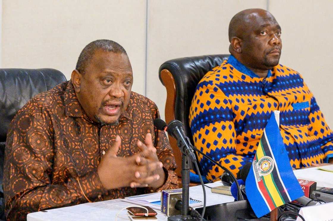 Former Kenyan president and East African Community's mediator Uhuru Kenyatta, left, called on armed groups to lay down their arms and 'choose the path of peace' Former Kenyan president and East African Community's mediator Uhuru Kenyatta, left, called on armed groups to lay down their arms and 'choose the path of peace'