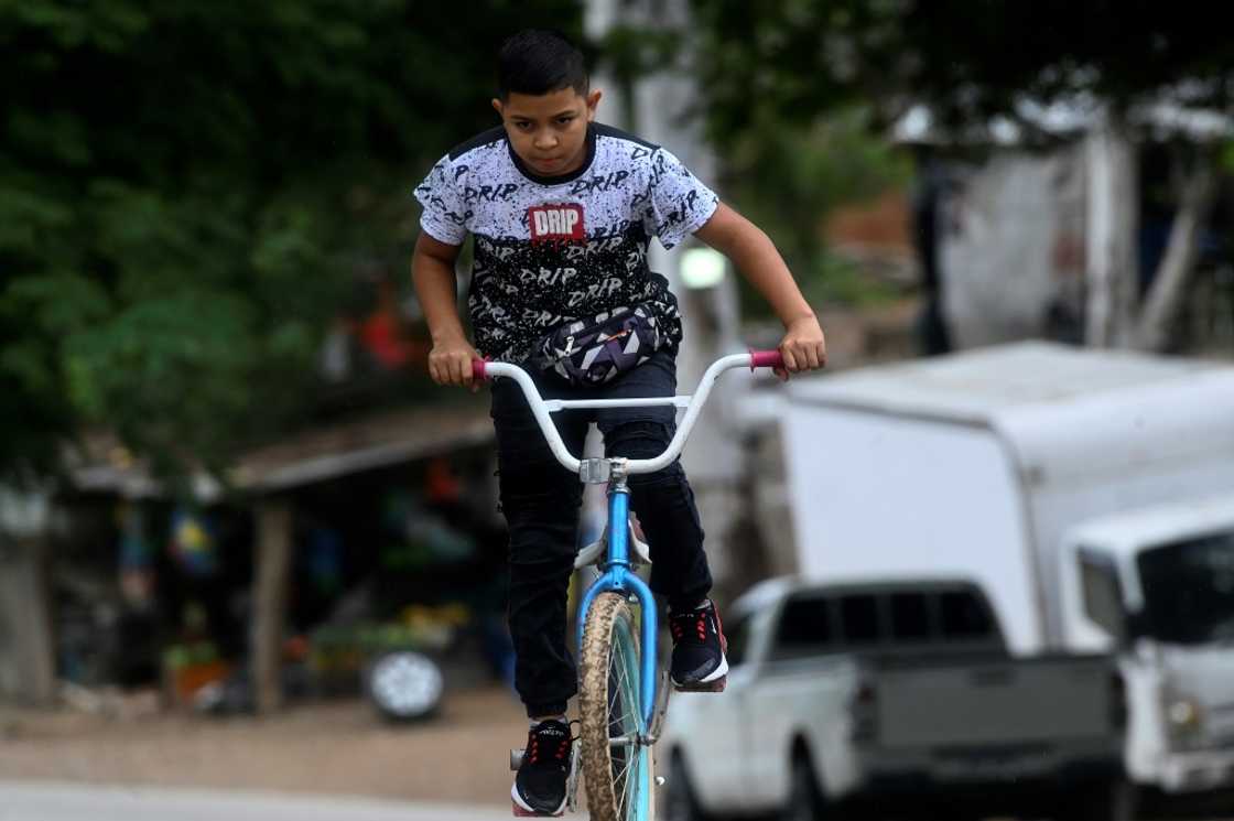 When there are no clients, Eduardo rides his bicycle or plays with his friends