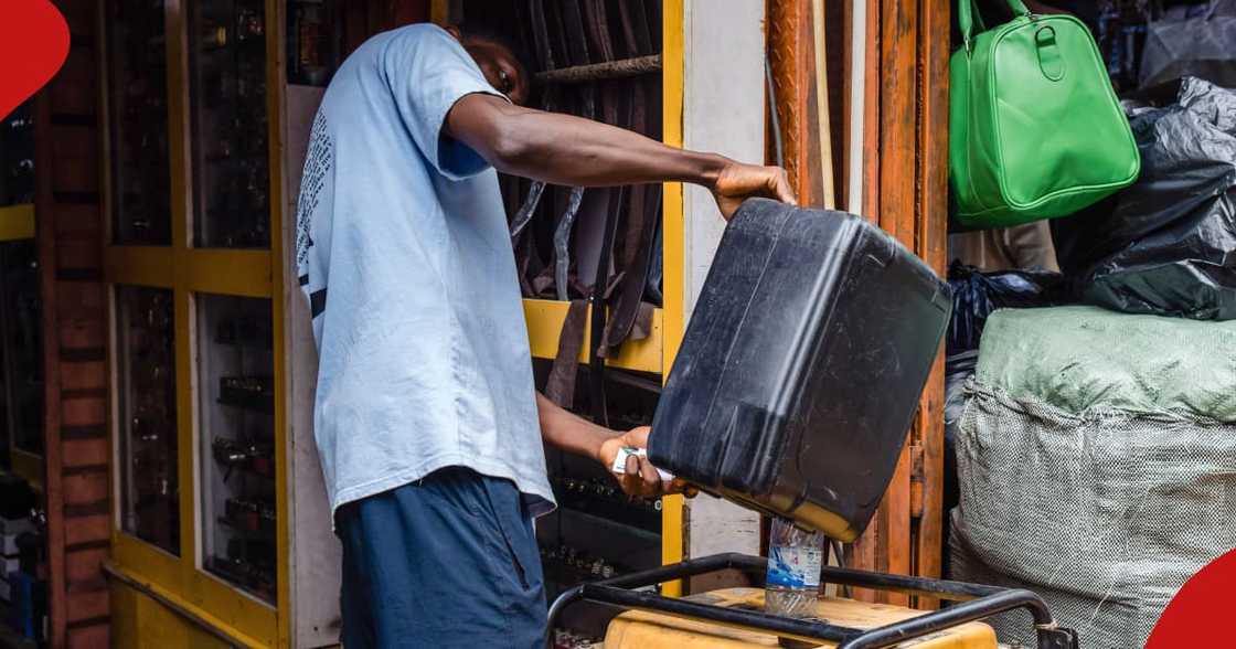A man in Nigeria fuels a generator. A man in Nigeria fuels a generator.