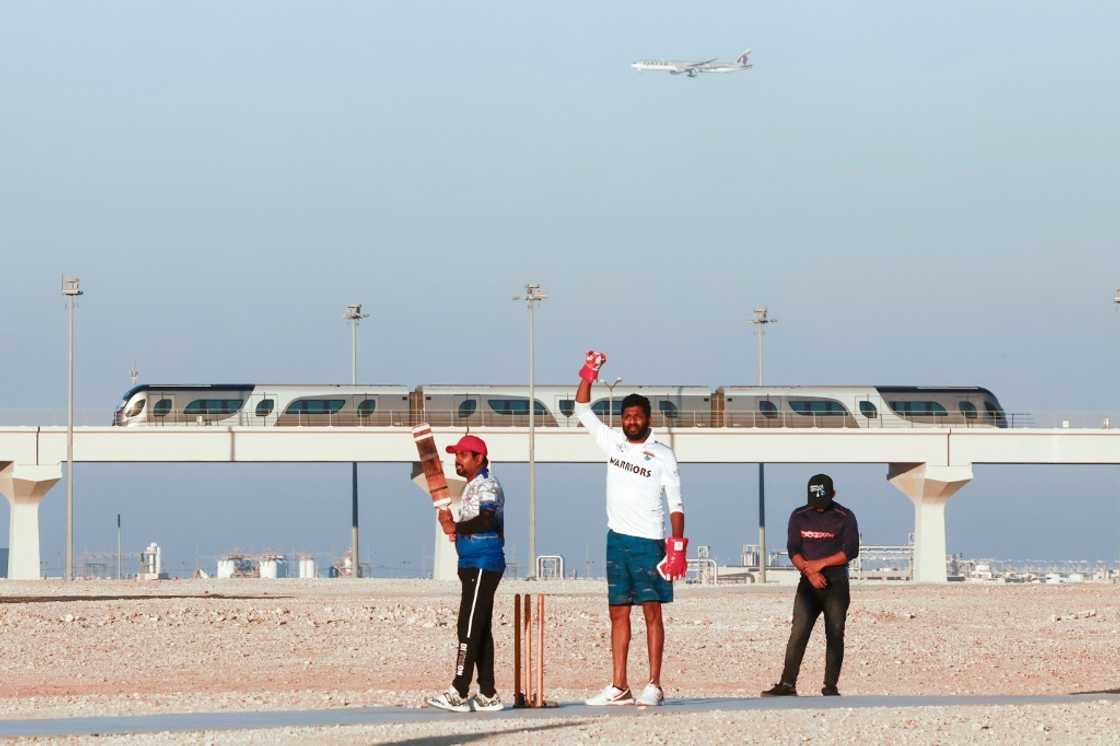 Indian expats play cricket alongside the metro in Al-Wakra City, just south of Doha