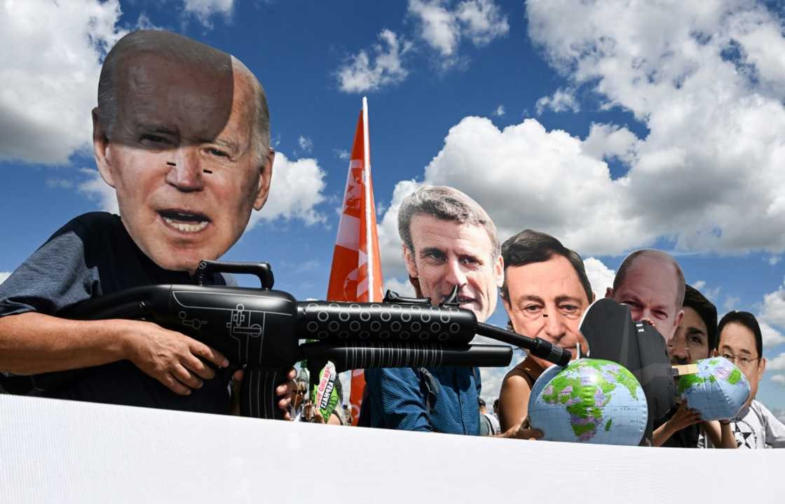 Protesters wearing masks depicting G7 leaders take part in a demonstration called by environmental groups to warn against rolling back on climate commitments Protesters wearing masks depicting G7 leaders take part in a demonstration called by environmental groups to warn against rolling back on climate commitments