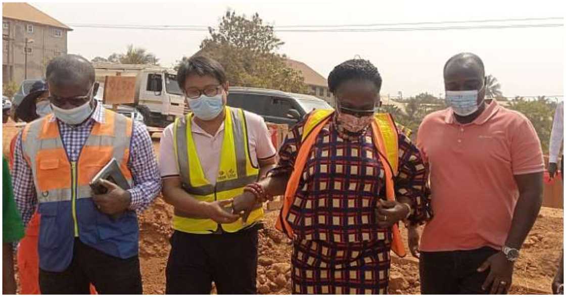 Mad. Owusu-Banahene inspects the construction site of the road project with contractors Mad. Owusu-Banahene inspects the construction site of the road project with contractors