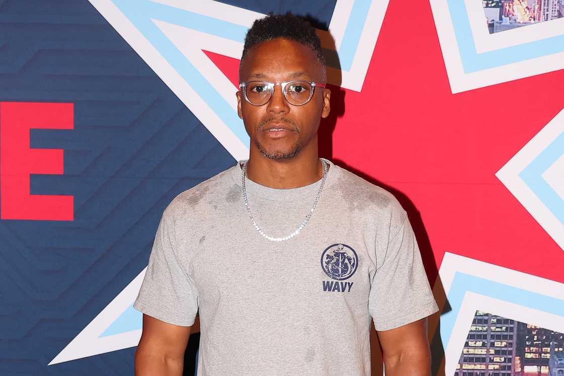 Lupe Fiasco poses for photos at the drivers meeting in the Chicago Stock Exchange