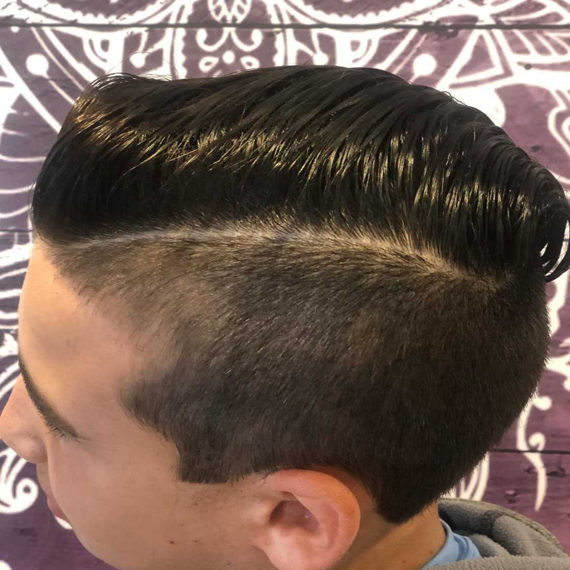 A boy is rocking a side parted haircut