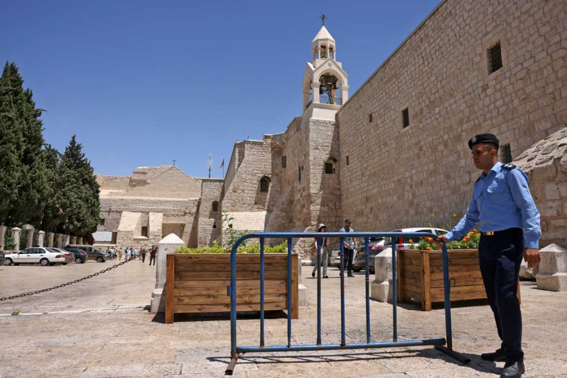 Security has been tightened ahead of US President Joe Biden's visit: here a policeman is seen outside the Church of the Nativity in Bethlehem in the occupied West Bank on July 14 Security has been tightened ahead of US President Joe Biden's visit: here a policeman is seen outside the Church of the Nativity in Bethlehem in the occupied West Bank on July 14