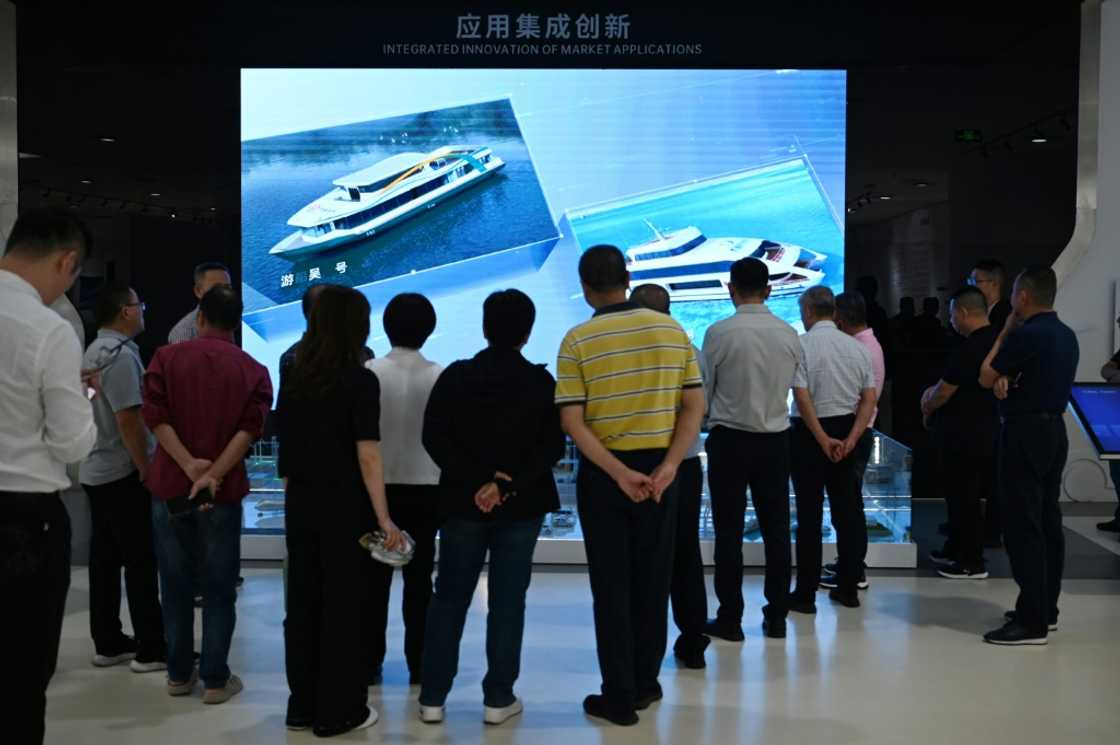 Visitors look at a video about battery-powered ships in the showroom at the headquarters of Chinese EV battery maker CATL in Ningde, Fujian province on November 15, 2024 Visitors look at a video about battery-powered ships in the showroom at the headquarters of Chinese EV battery maker CATL in Ningde, Fujian province on November 15, 2024