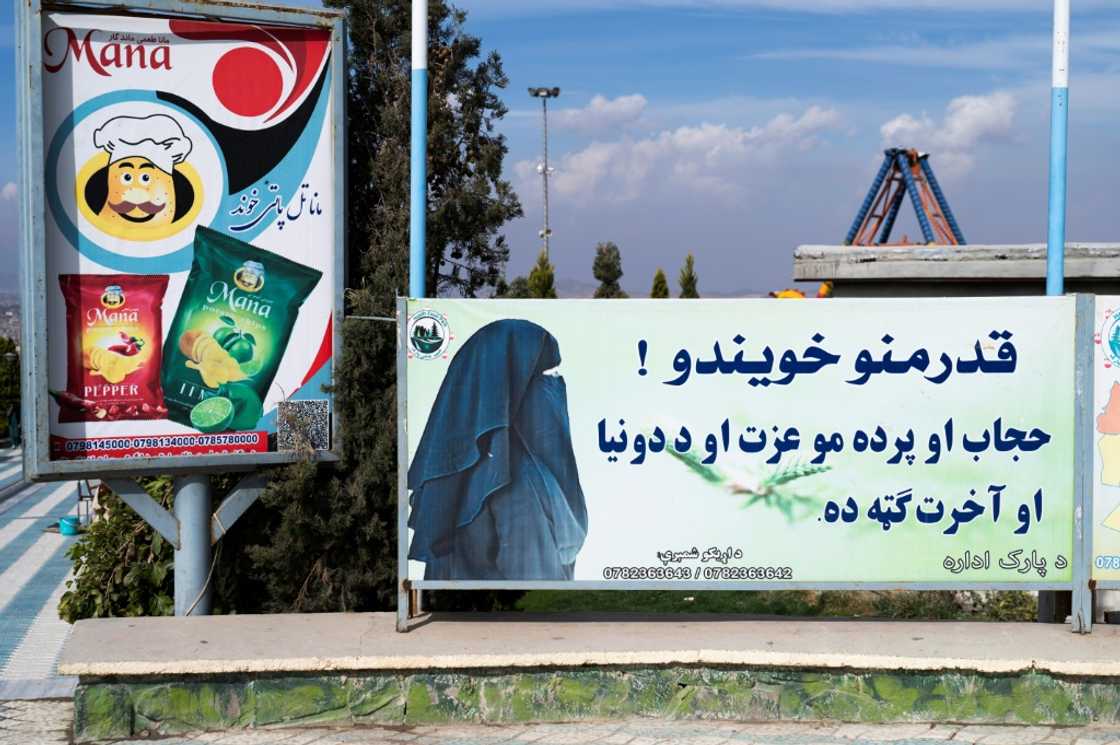 A poster near Zazai Park in Kabul reads: 'Dear sisters! Hijab and veil are your dignity and are in your benefit in this world and in the hereafter' A poster near Zazai Park in Kabul reads: 'Dear sisters! Hijab and veil are your dignity and are in your benefit in this world and in the hereafter'