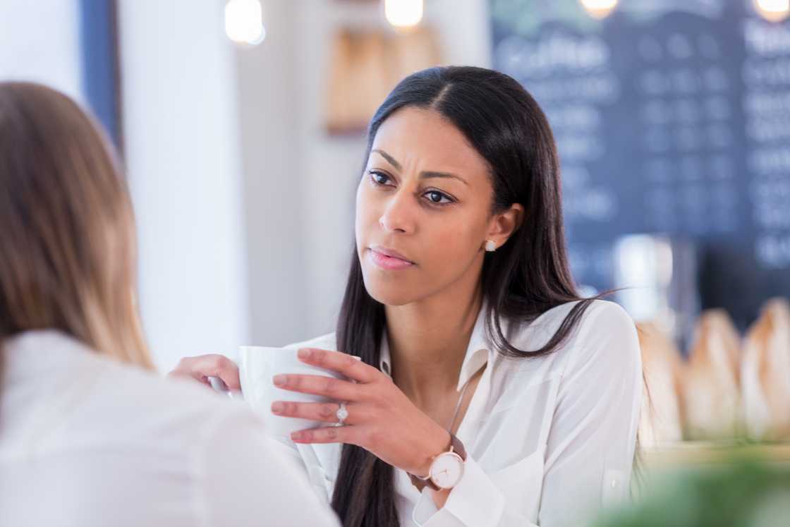 Two ladies at a cafe talking