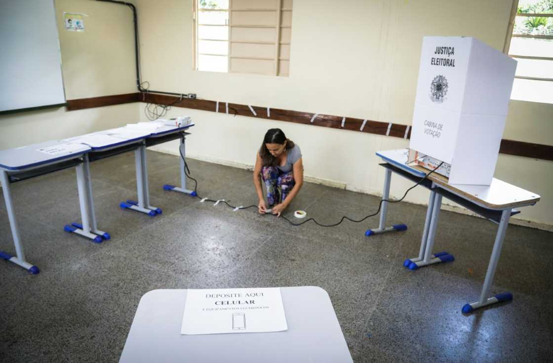 A staffer connects the electronic ballot box at a polling station on the eve of the presidential election in Brasilia on October 1, 2022. A staffer connects the electronic ballot box at a polling station on the eve of the presidential election in Brasilia on October 1, 2022.