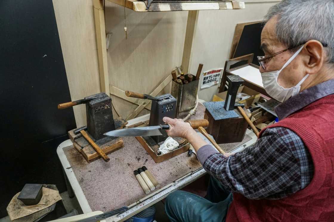 A craftsman attaches a handle to a 'gyuto', the Japanese equivalent to a western chef's knife, at Yamawaki Cutlery in Osaka prefecture A craftsman attaches a handle to a 'gyuto', the Japanese equivalent to a western chef's knife, at Yamawaki Cutlery in Osaka prefecture