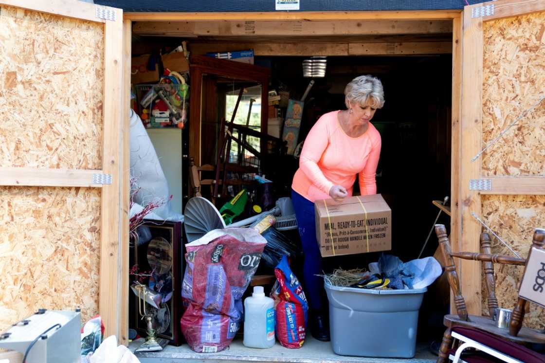 Christy White salvages items from a shed outside her flooded home in Lost Creek, Kentucky, September 29, 2022 Christy White salvages items from a shed outside her flooded home in Lost Creek, Kentucky, September 29, 2022