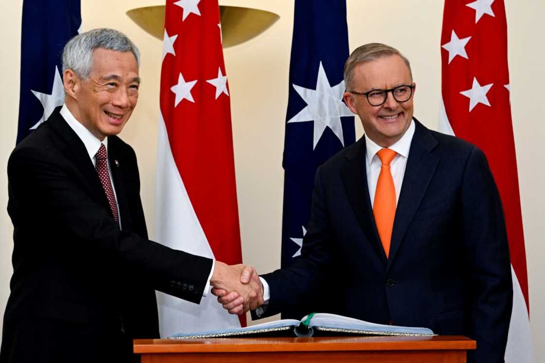 Australia's Prime Minister Anthony Albanese (R) shakes hands with Singapore's Prime Minister Lee Hsien Loong during their meeting at Parliament House in Canberra on October 18, 2022. Australia's Prime Minister Anthony Albanese (R) shakes hands with Singapore's Prime Minister Lee Hsien Loong during their meeting at Parliament House in Canberra on October 18, 2022.