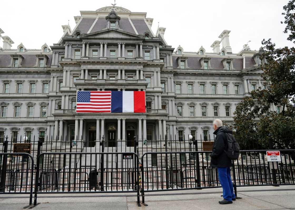 French and US flags adorn the Eisenhower Executive Office Building next to the White House for the state visit of French President Emmanuel Macron who arrives in Washington on November 29, 2022 French and US flags adorn the Eisenhower Executive Office Building next to the White House for the state visit of French President Emmanuel Macron who arrives in Washington on November 29, 2022