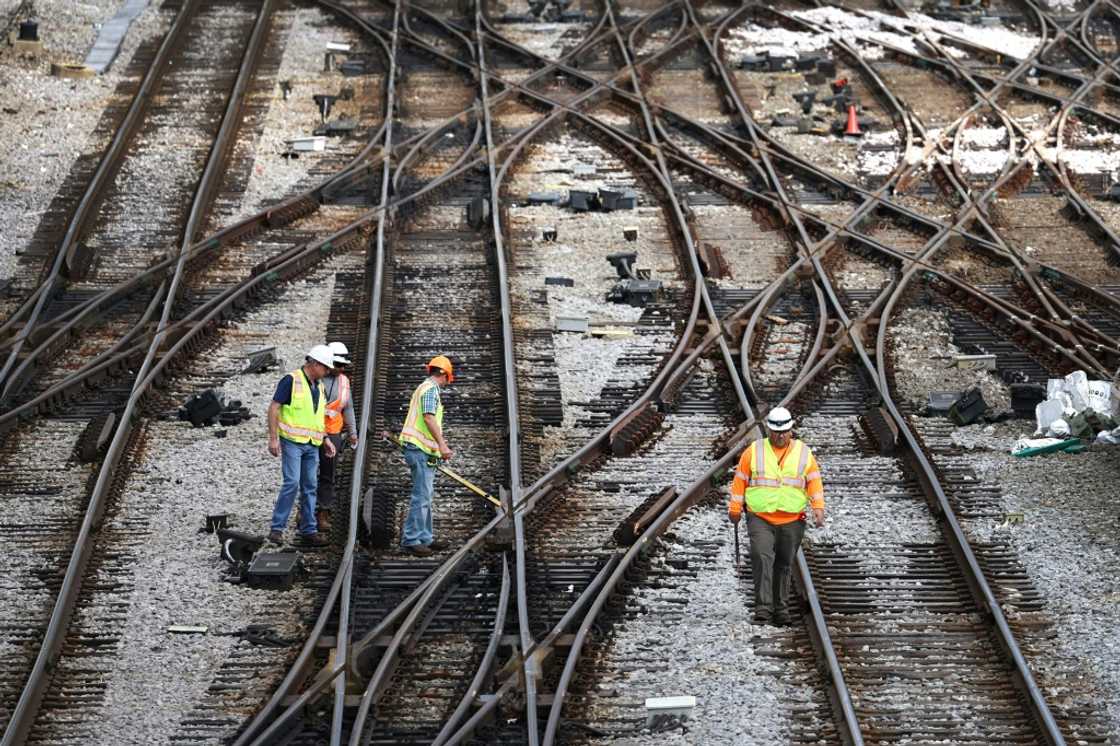 Workers service the tracks at the Metra/BNSF railroad yard outside of Chicago Workers service the tracks at the Metra/BNSF railroad yard outside of Chicago