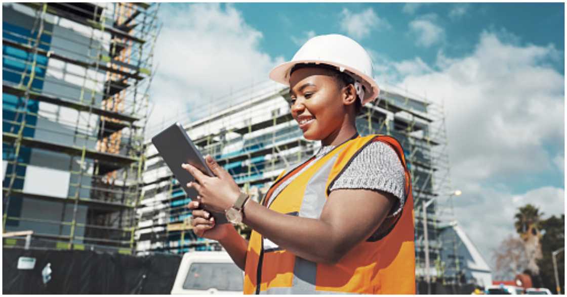 A real estate developer looks at her electronic gadget A real estate developer looks at her electronic gadget