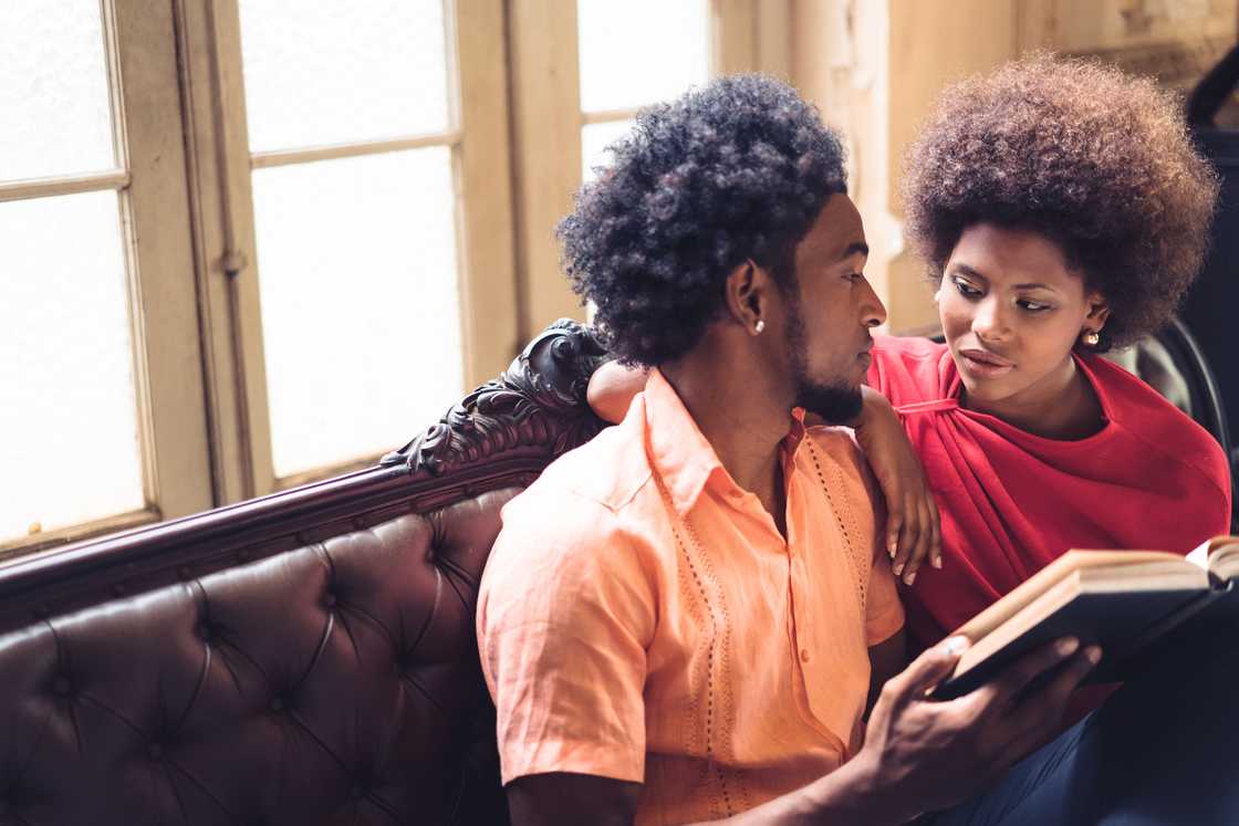 A couple reading quietly in their living room. A couple reading quietly in their living room.