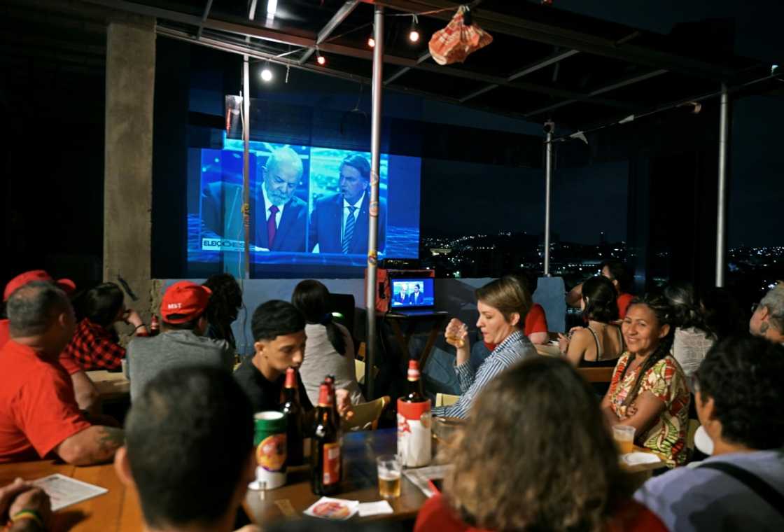 Disinformation wars on TV: Brazilians watch a presidential debate between incumbent Jair Bolsonaro and front-runner Luiz Inacio Lula da Silva at a Rio de Janeiro bar on August 29 Disinformation wars on TV: Brazilians watch a presidential debate between incumbent Jair Bolsonaro and front-runner Luiz Inacio Lula da Silva at a Rio de Janeiro bar on August 29
