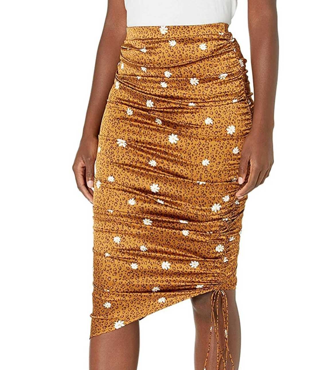 A woman is dressed in a knee-length asymmetrical skirt A woman is dressed in a knee-length asymmetrical skirt