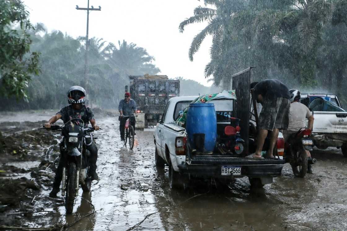 Residents leave their homes in the municipality of El Progreso, Honduras under pouring rain on October 8, 2022 before the arrival of Hurricane Julia Residents leave their homes in the municipality of El Progreso, Honduras under pouring rain on October 8, 2022 before the arrival of Hurricane Julia