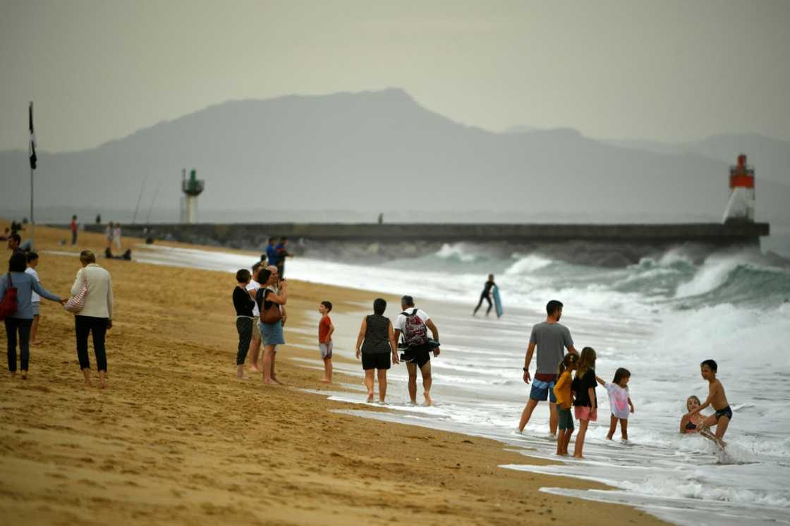 Warm October weather has seen many flock to the beach -- such as here at Hossegor, southwestern France -- but environmentalists see more evidence of climate change