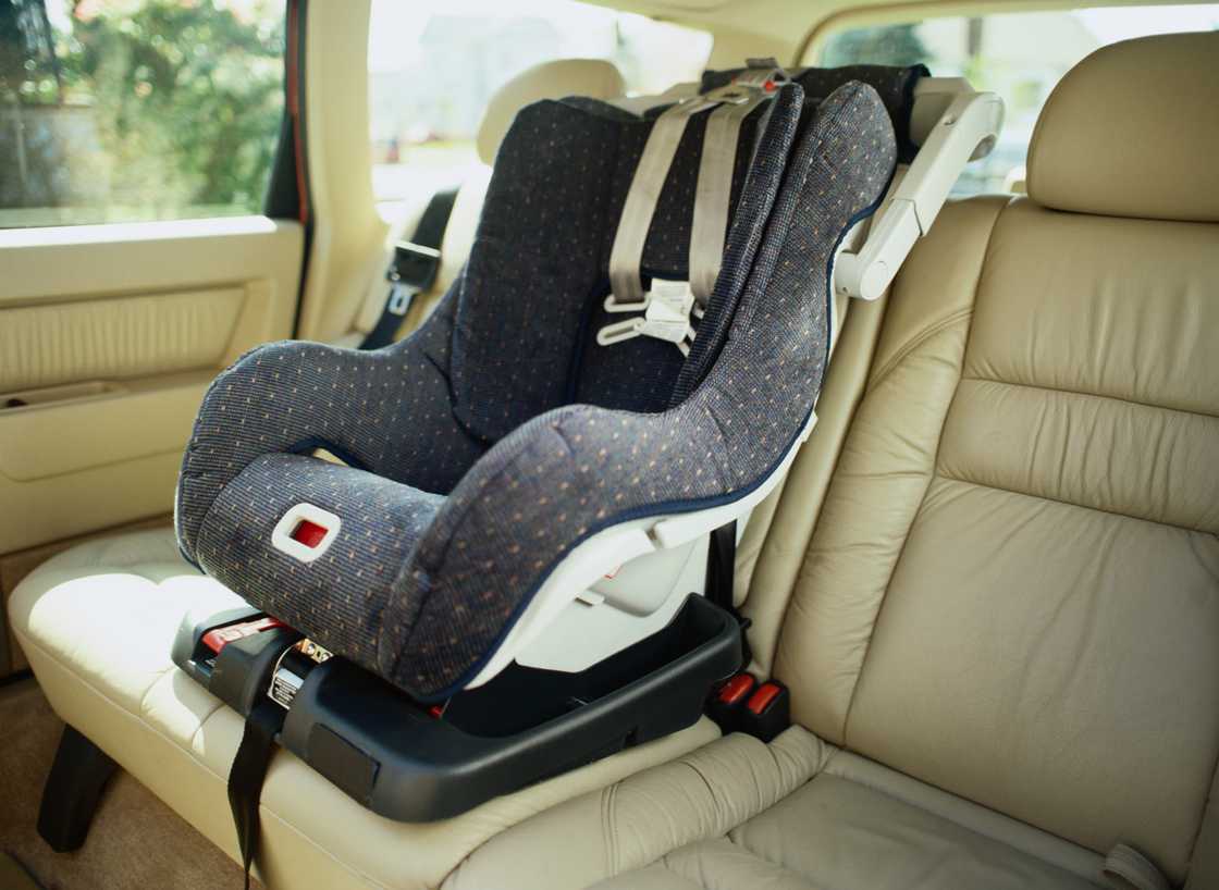 A baby seat is at the centre of the back car seat A baby seat is at the centre of the back car seat
