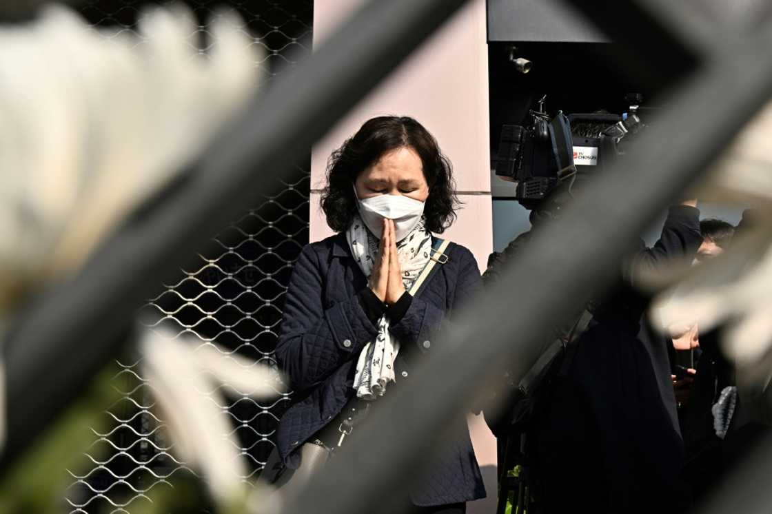 A woman prays in tribute to those who were killed in Seoul's Itaewon district during a Halloween crush at a makeshift memorial A woman prays in tribute to those who were killed in Seoul's Itaewon district during a Halloween crush at a makeshift memorial