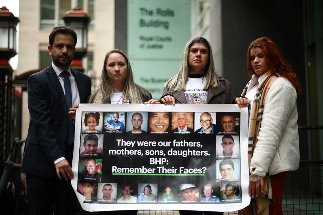 A banner outside the High Court in London showing victims of the mine disaster A banner outside the High Court in London showing victims of the mine disaster