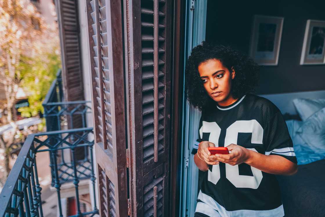 A lady taking a call from the balcony