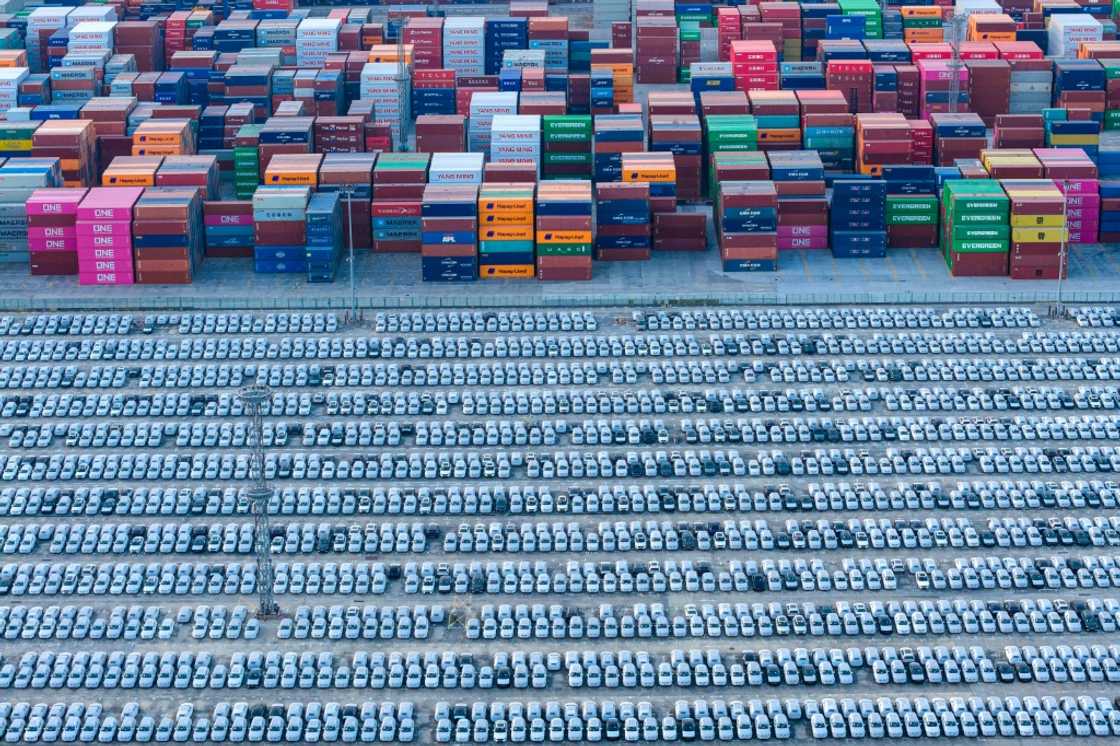 An aerial view of vehicles awaiting their export at a port in Nanjing, eastern China's Jiangsu province on December 9, 2025