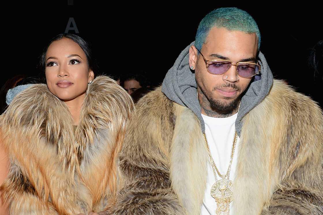 Karrueche Tran (L) and Chris Brown (R) in fur coats Karrueche Tran (L) and Chris Brown (R) in fur coats