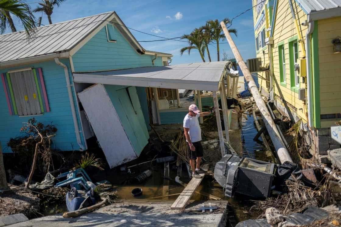 A man stands in front of his destroyed house in the aftermath of Hurricane Ian in Matlacha, Florida A man stands in front of his destroyed house in the aftermath of Hurricane Ian in Matlacha, Florida