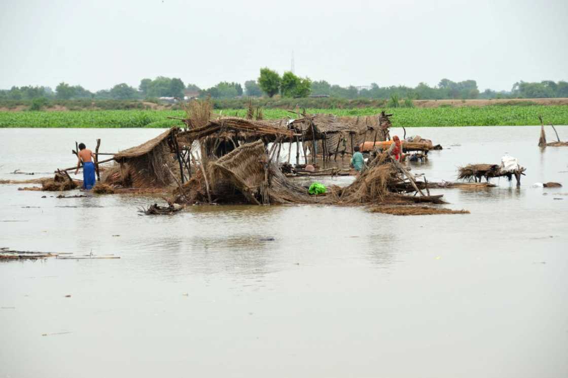 Villagers search for their belongings after their huts were destroyed by flood waters in Jaffarabad, Balochistan province Villagers search for their belongings after their huts were destroyed by flood waters in Jaffarabad, Balochistan province