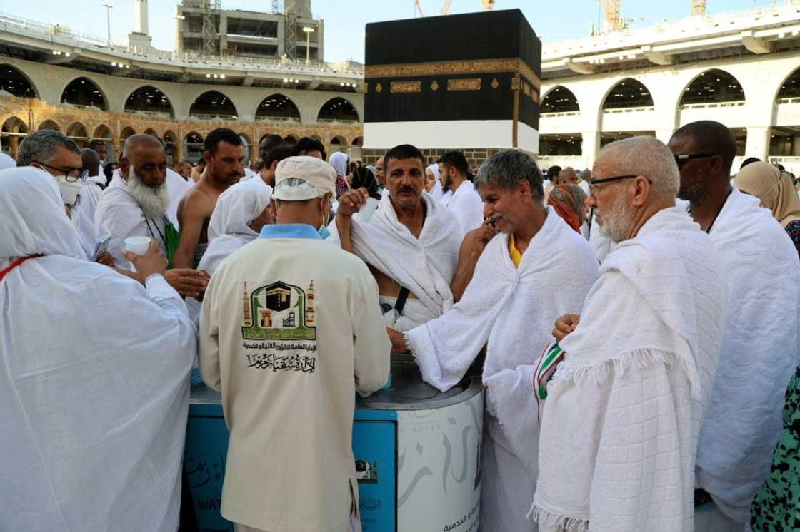 Worshippers walk side by side on the white floors near the Kaaba, the majority without a mask even though authorities said last month they would be mandatory at the site