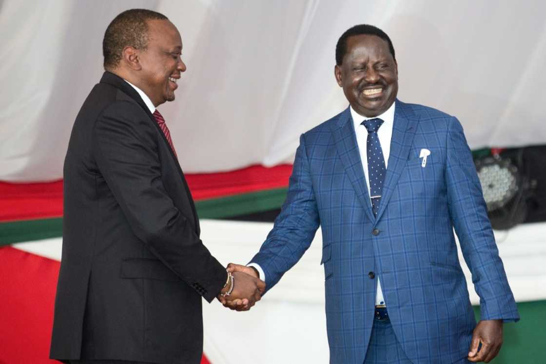 Friends: Kenyatta, left, and Odinga press the flesh at a prayer breakfast in May 2018 Friends: Kenyatta, left, and Odinga press the flesh at a prayer breakfast in May 2018