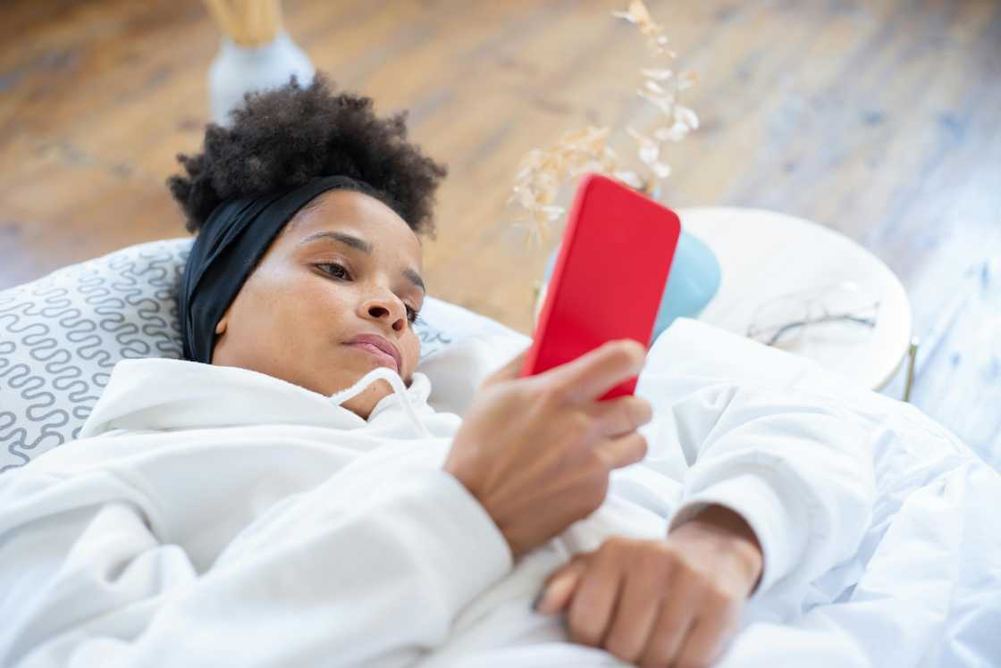 A woman checking her phone in the morning A woman checking her phone in the morning