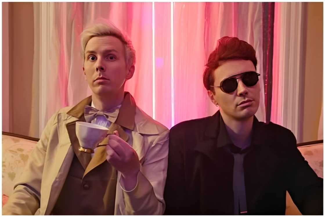 Phil, holding a cup, and Dan, wearing a black shirt. Phil, holding a cup, and Dan, wearing a black shirt.