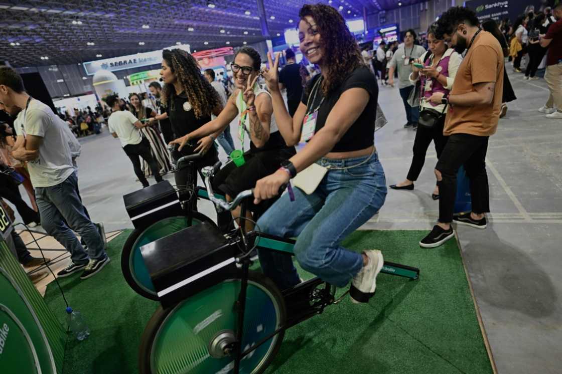 People ride stationary bikes to create energy during the Web Summit Rio 2024 on April 17, 2024 People ride stationary bikes to create energy during the Web Summit Rio 2024 on April 17, 2024