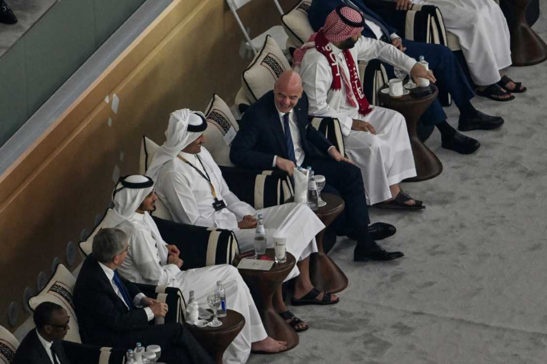 FIFA President Gianni Infantino (C) chats with Saudi Arabia's Crown Prince Mohammed bin Salman (R), wearing a scarf in Qatari colours, and Qatar's Emir Sheikh Tamim bin Hamad al-Thani (4th L) on World Cup opening day FIFA President Gianni Infantino (C) chats with Saudi Arabia's Crown Prince Mohammed bin Salman (R), wearing a scarf in Qatari colours, and Qatar's Emir Sheikh Tamim bin Hamad al-Thani (4th L) on World Cup opening day