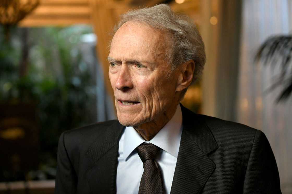 Clint Eastwood in a black suit and tie Clint Eastwood in a black suit and tie