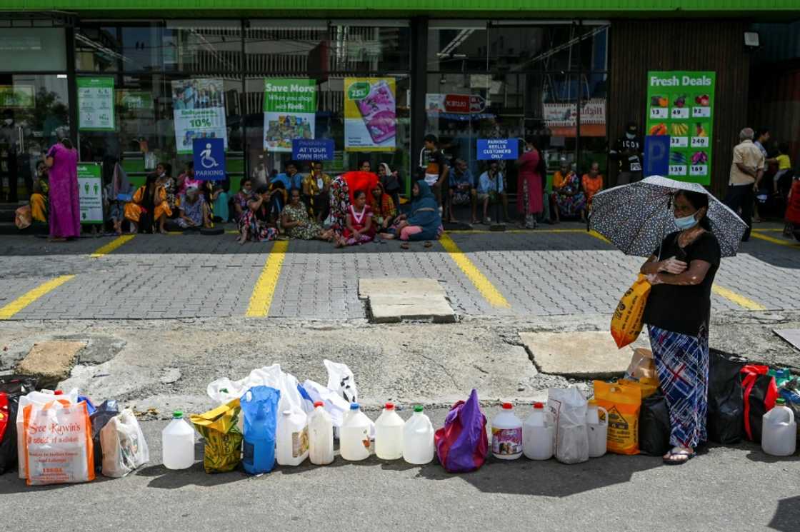 Sri Lankans wait in snaking queues for food and fuel after the government ran out of dollars last year to finance imports