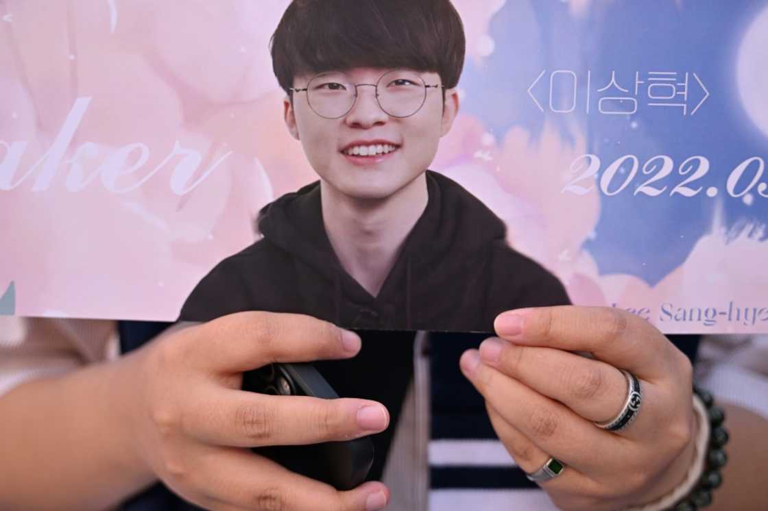 A fans shows off memorabilia of South Korea’s eSports player Lee Sang-hyeok, also known as Faker A fans shows off memorabilia of South Korea’s eSports player Lee Sang-hyeok, also known as Faker