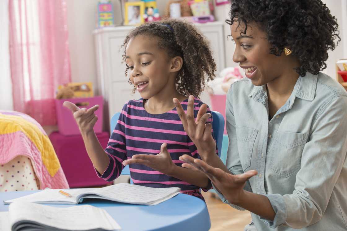 A woman and a daughter communicating in sign language