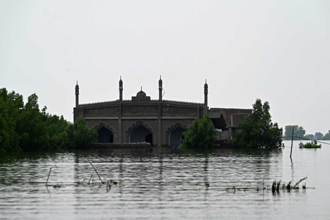 The single road leading to Basti Ahmad Din is submerged, leaving boats as the only way in or out The single road leading to Basti Ahmad Din is submerged, leaving boats as the only way in or out
