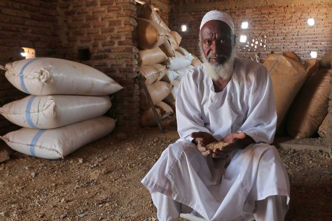 Sudanese farmer Modawi Ahmed is seen inside his granary in the village of Al-Laota, southwest of the capital Khartoum. He says the bank only agreed to buy less than half of his harvest, and he now fears the rest will spoil Sudanese farmer Modawi Ahmed is seen inside his granary in the village of Al-Laota, southwest of the capital Khartoum. He says the bank only agreed to buy less than half of his harvest, and he now fears the rest will spoil