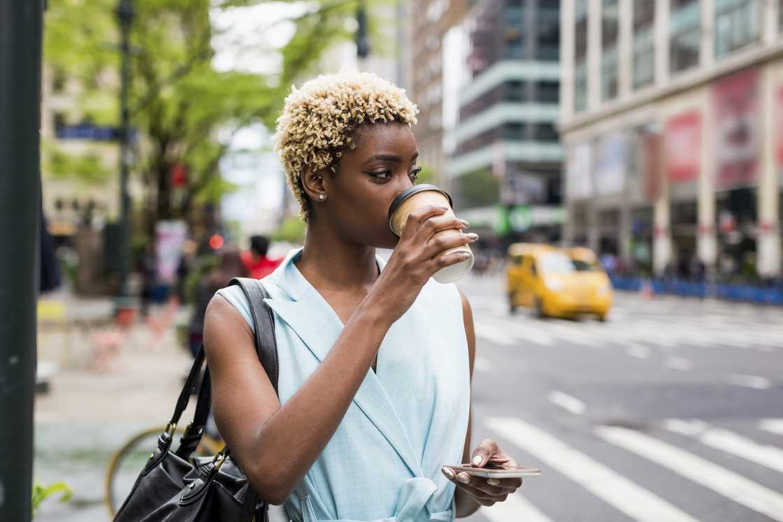 A lady sipping coffee in the streets