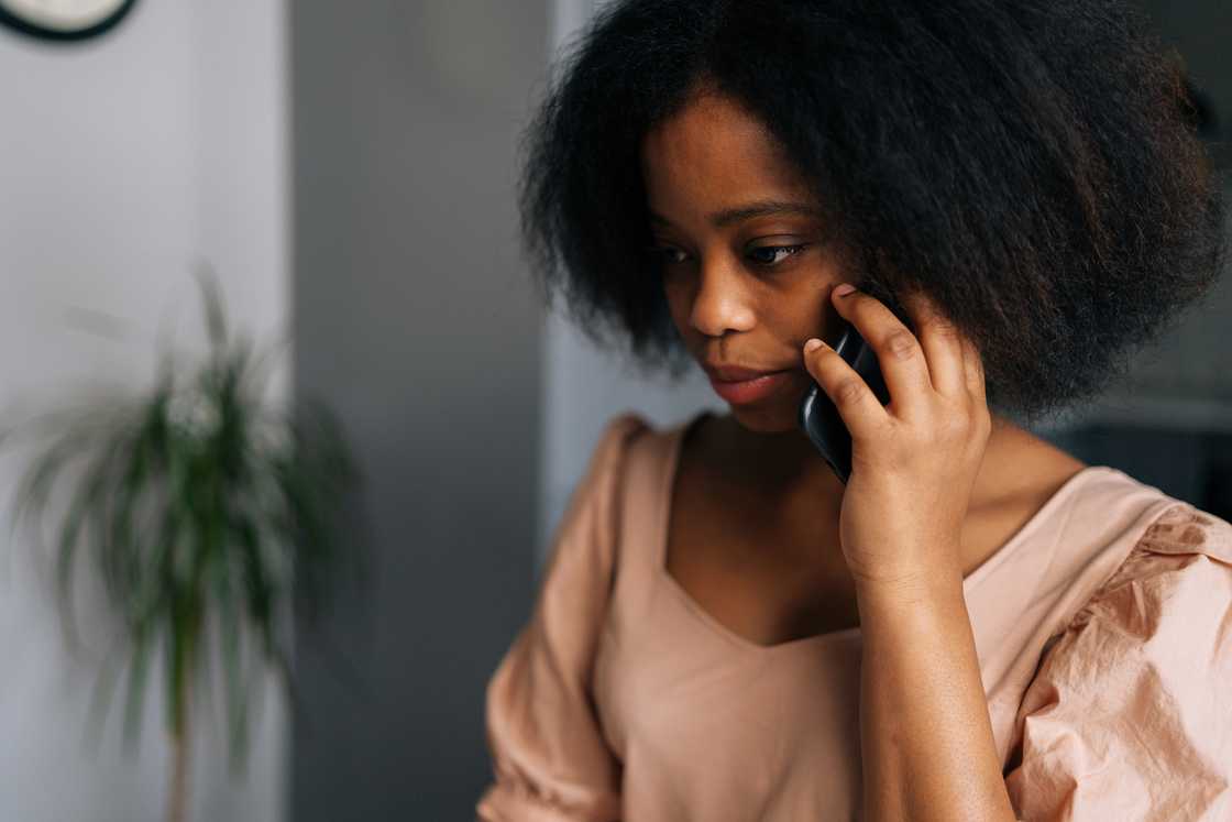 A young woman talking on smartphone at home. A young woman talking on smartphone at home.