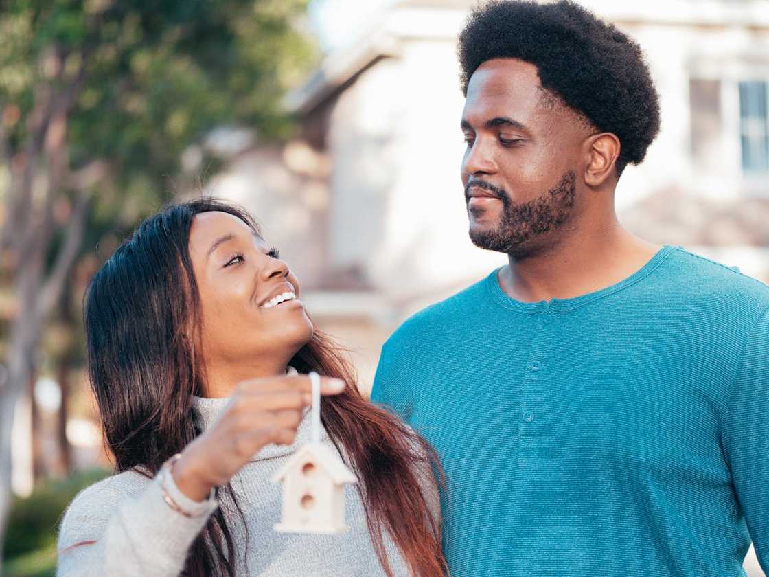 A couple smile and talk outdoors. A couple smile and talk outdoors.